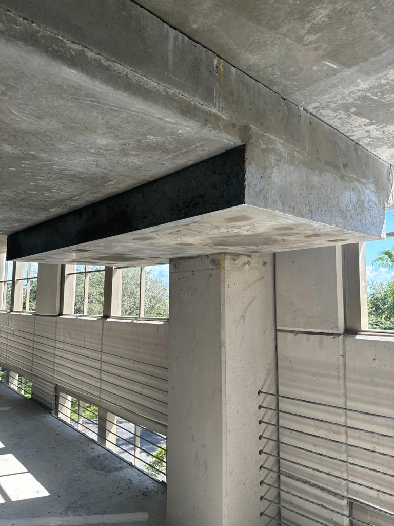 After identifying punching shear issues at a parking structure’s filigree beams, drop panels were installed to restore structural integrity.